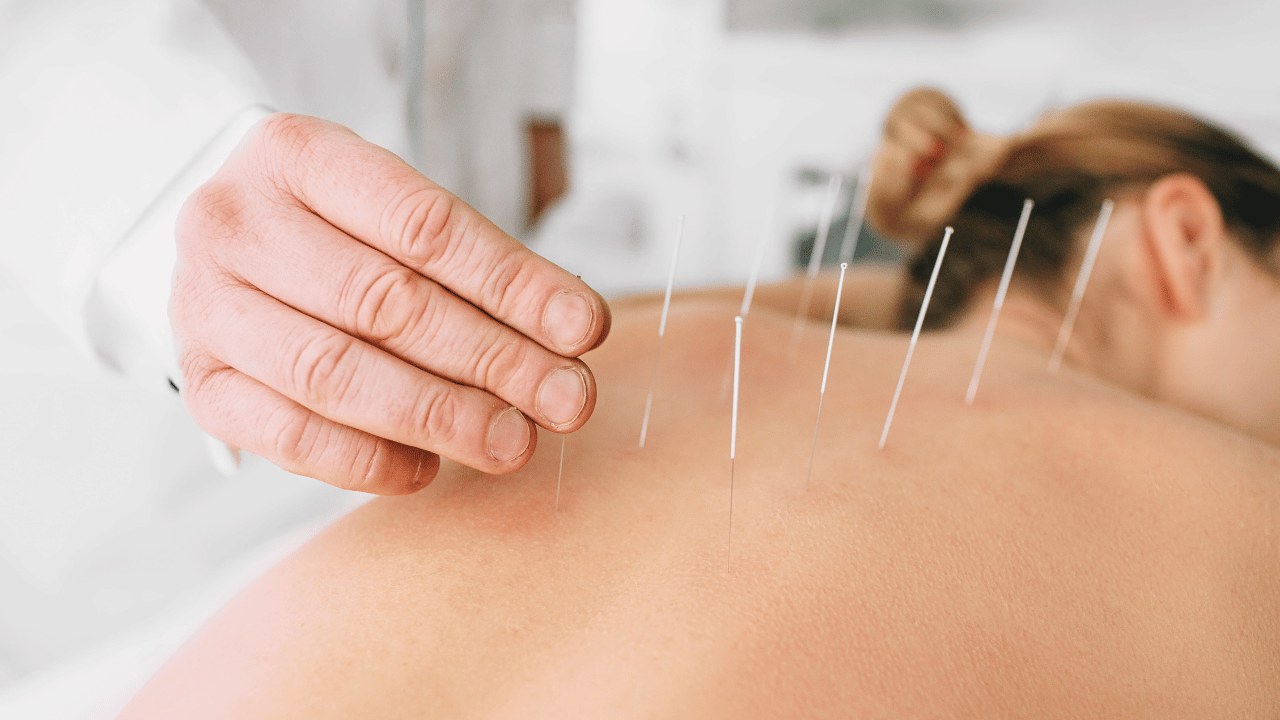 A woman receiving holistic therapy with biomagnetic therapy in Fort Lauderdale, Florida. atma acupuncture