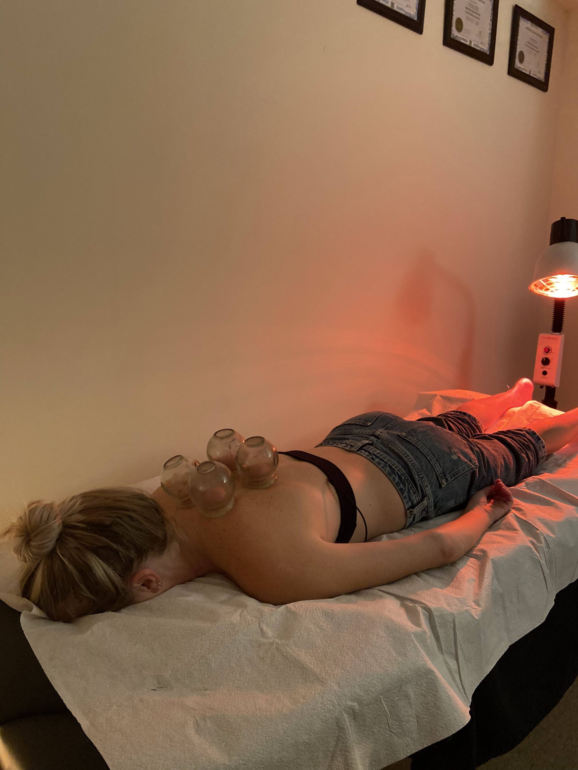 A woman receiving holistic therapy in Fort Lauderdale, Florida, with a red light on her head. atma acupuncture