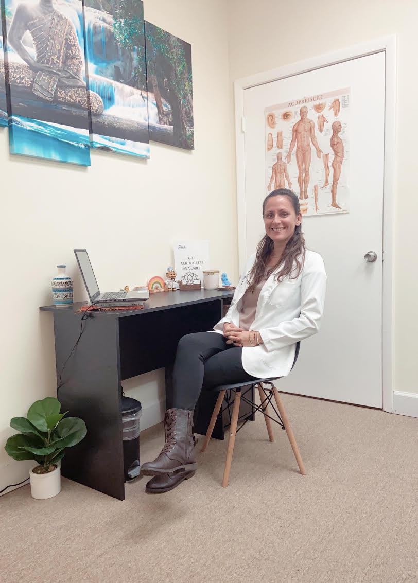 A woman practicing alternative medicine in her office, utilizing biomagnetic therapy and cupping therapy. atma acupuncture