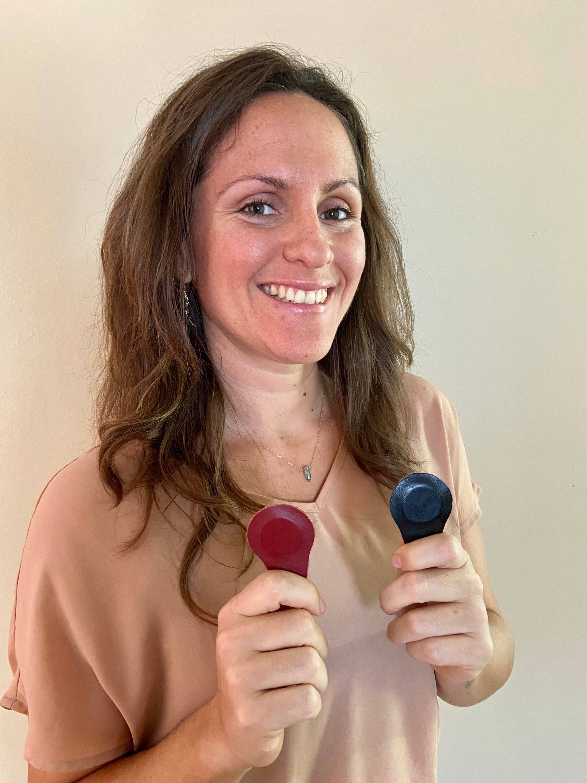A woman practicing holistic therapy in Fort Lauderdale, cupping therapy, holding a pair of earplugs in her hands. atma acupuncture